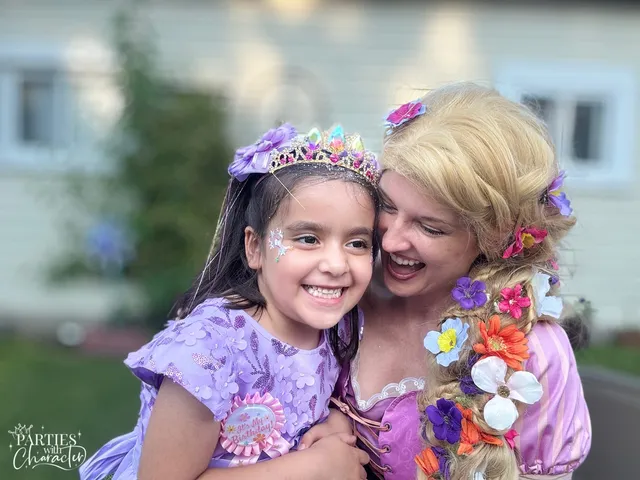 Rapunzel hugging a young boy tightly at an outdoor gathering