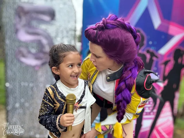 Rumi and a young girl sharing a playful laugh side by side